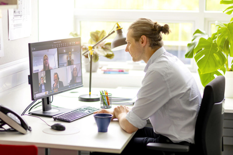 Online MBA student participating in a group video meeting